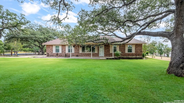 ranch-style home featuring a front yard