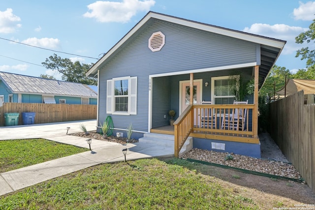 view of front of house featuring a front yard and covered porch