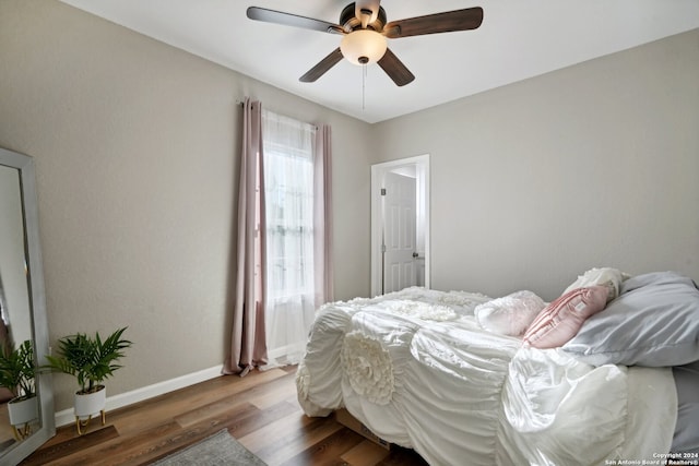 bedroom with ceiling fan and dark hardwood / wood-style floors