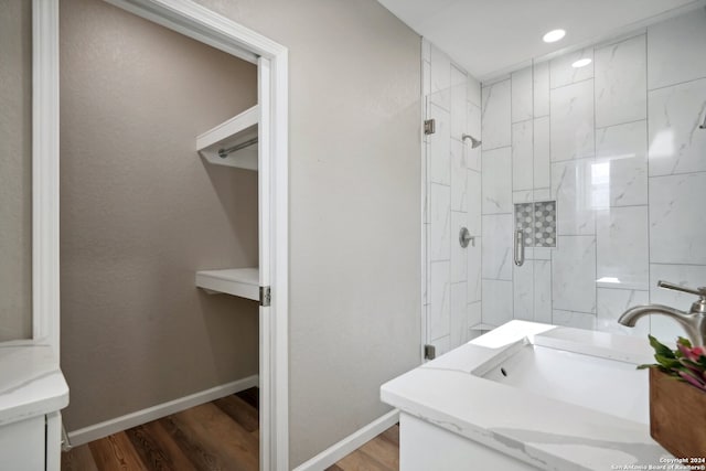 bathroom with vanity, hardwood / wood-style floors, and a shower with shower door