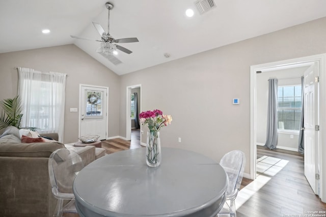 dining room featuring ceiling fan, light hardwood / wood-style floors, and vaulted ceiling