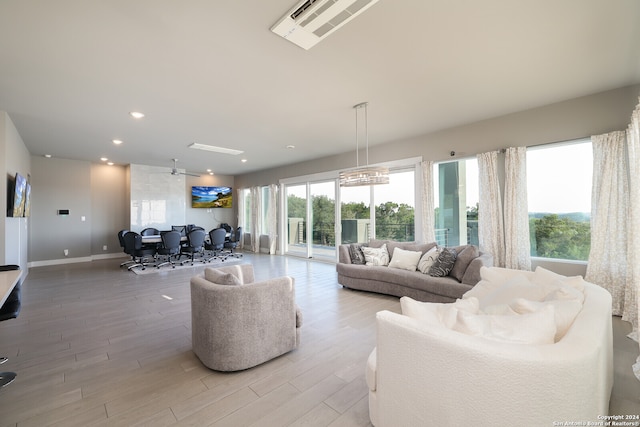 living room with a chandelier and light hardwood / wood-style floors