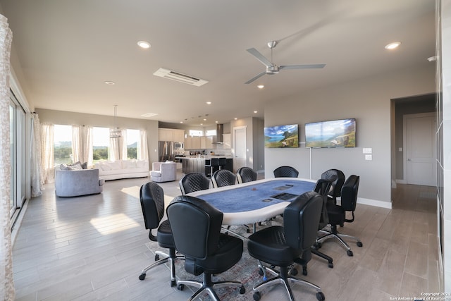 office with light hardwood / wood-style flooring and ceiling fan