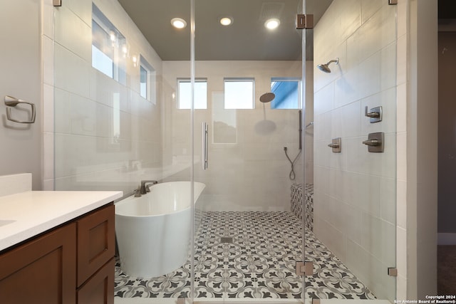 bathroom featuring tile patterned floors, separate shower and tub, and vanity