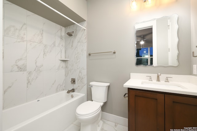 full bathroom featuring toilet, tiled shower / bath combo, and vanity