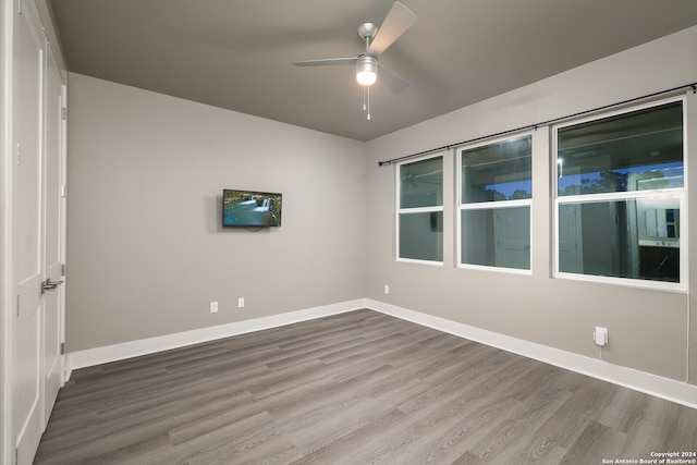 unfurnished room featuring ceiling fan and wood-type flooring