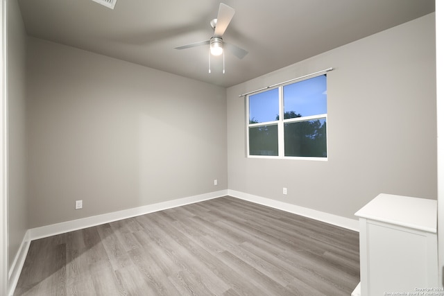 unfurnished room featuring hardwood / wood-style floors and ceiling fan