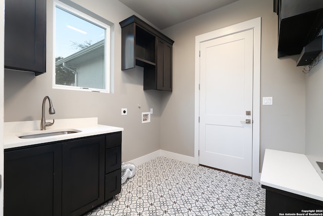 washroom featuring hookup for a washing machine, cabinets, sink, and hookup for an electric dryer