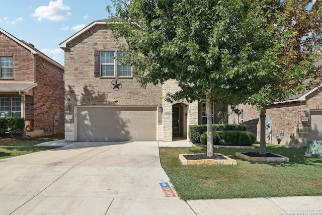 view of front of house with a garage and a front yard