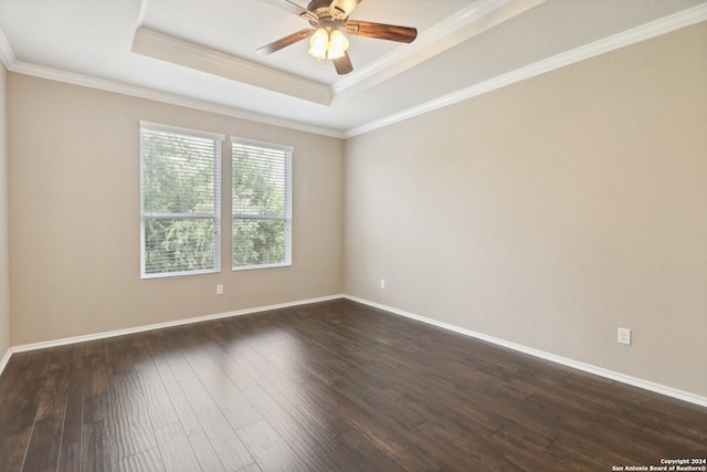 unfurnished room with crown molding, dark wood-type flooring, a tray ceiling, and ceiling fan