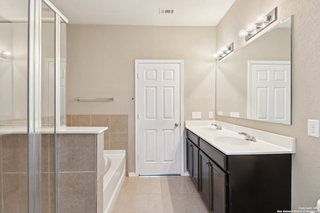 bathroom with tile patterned floors, independent shower and bath, and vanity