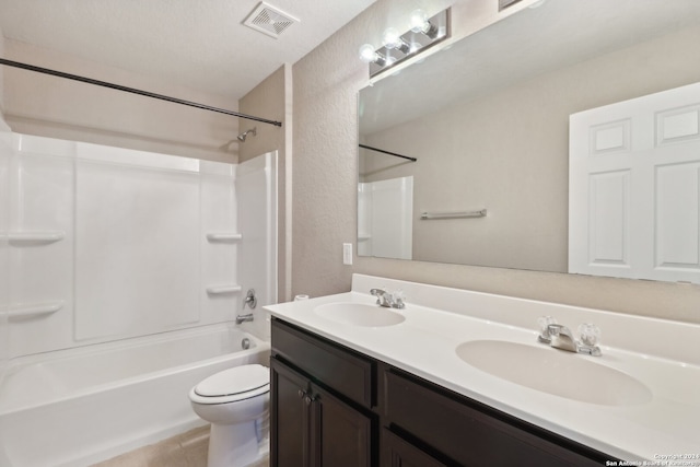 full bathroom featuring toilet, a textured ceiling, shower / washtub combination, and vanity