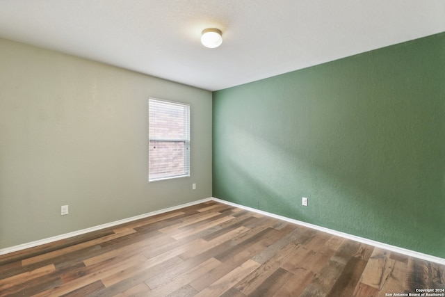 unfurnished room featuring wood-type flooring