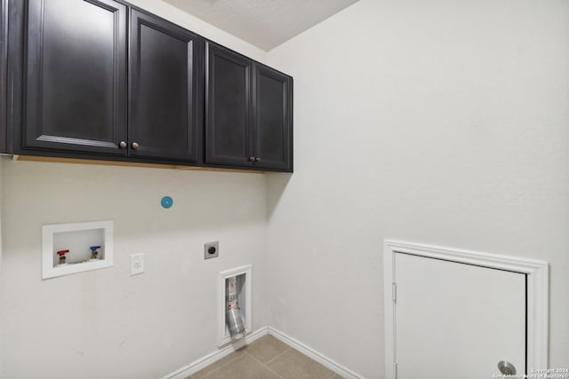 washroom featuring washer hookup, cabinets, light tile patterned floors, and electric dryer hookup