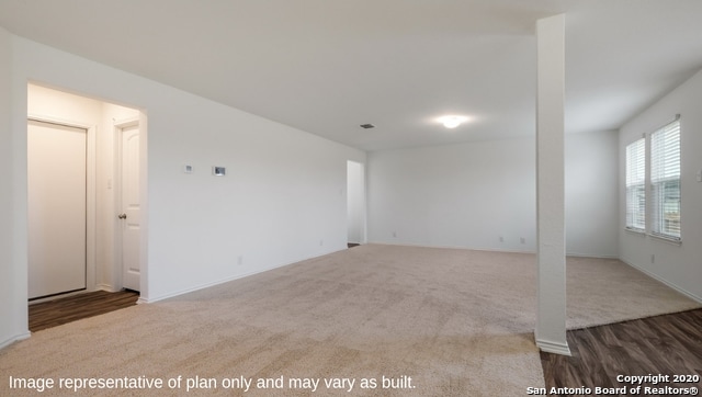 unfurnished room with dark colored carpet