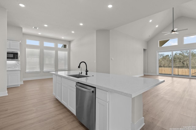 kitchen featuring white cabinetry, sink, an island with sink, and appliances with stainless steel finishes