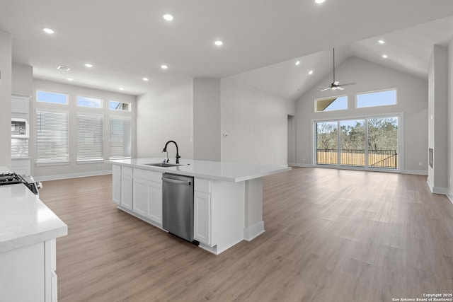 kitchen with white cabinetry, an island with sink, sink, stainless steel appliances, and light wood-type flooring