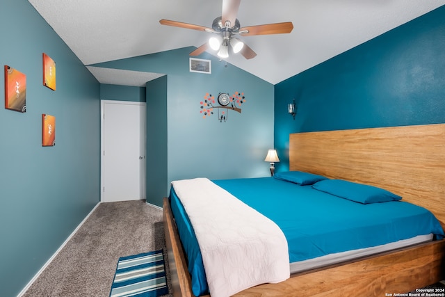 carpeted bedroom with vaulted ceiling and ceiling fan