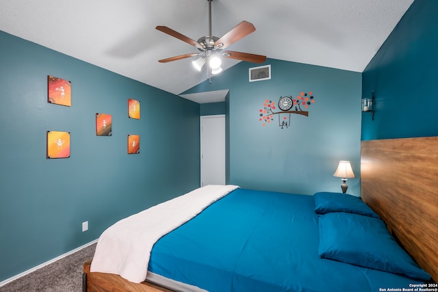 carpeted bedroom with ceiling fan and vaulted ceiling