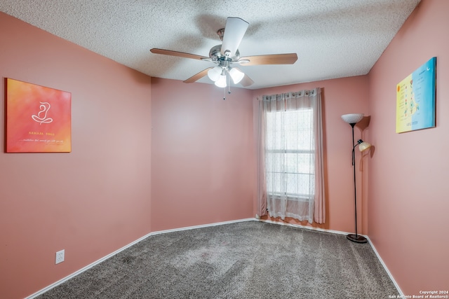 carpeted empty room with a textured ceiling and ceiling fan