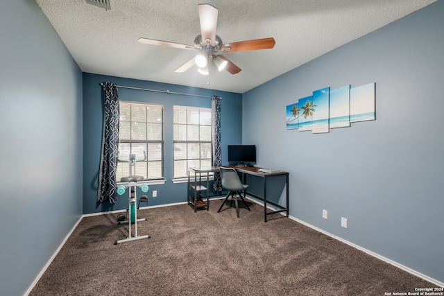 office area featuring ceiling fan, carpet, and a textured ceiling