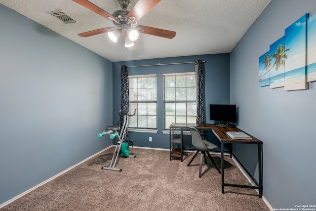 office area with ceiling fan, carpet, and a textured ceiling