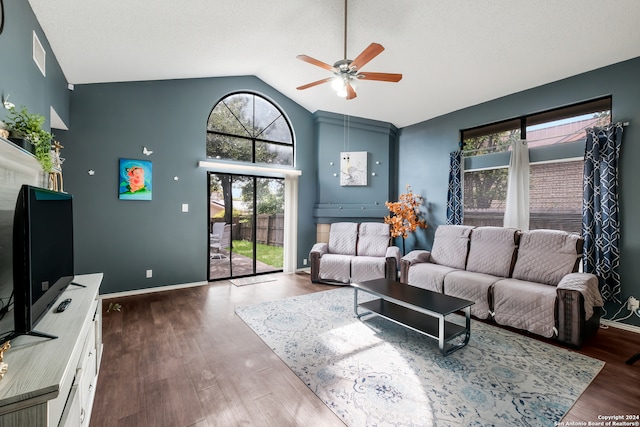 living room featuring dark hardwood / wood-style flooring, a wealth of natural light, and ceiling fan