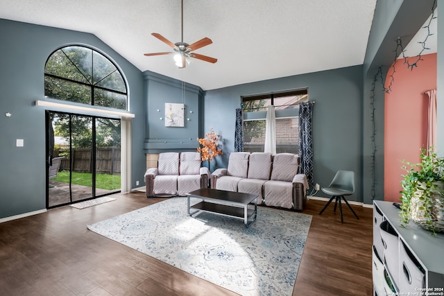 living room with dark wood-type flooring, plenty of natural light, and ceiling fan