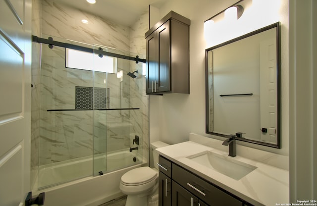 full bathroom with shower / bath combination with glass door, vanity, and toilet