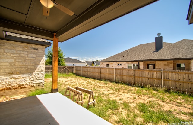 view of yard with ceiling fan and a patio area