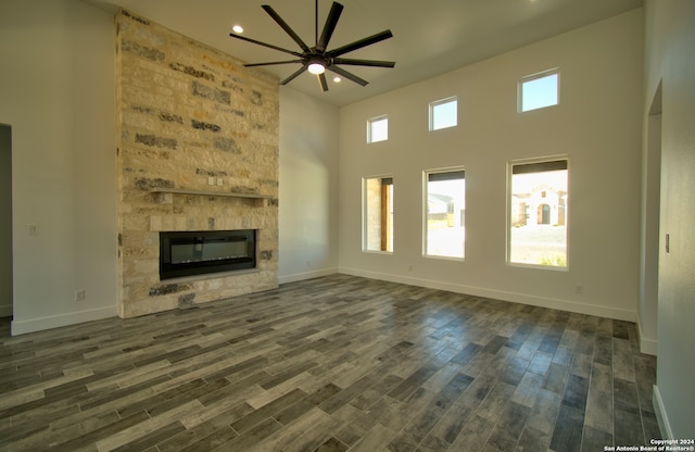 unfurnished living room featuring dark hardwood / wood-style flooring, ceiling fan, and a wealth of natural light