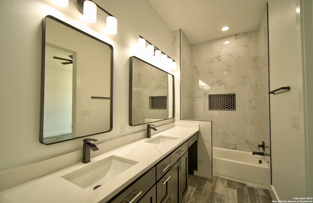 bathroom with tiled shower / bath, vanity, and hardwood / wood-style floors