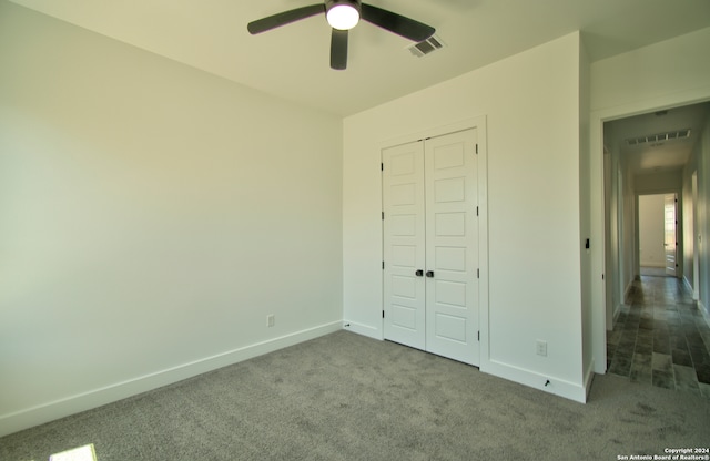 unfurnished bedroom featuring a closet, carpet, and ceiling fan