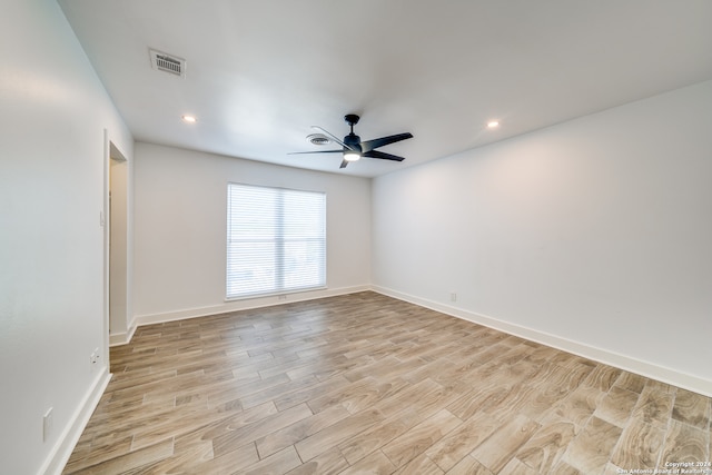 unfurnished room with ceiling fan and light hardwood / wood-style floors