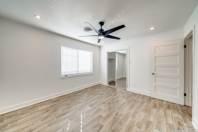 unfurnished bedroom with ceiling fan, a closet, and light hardwood / wood-style floors