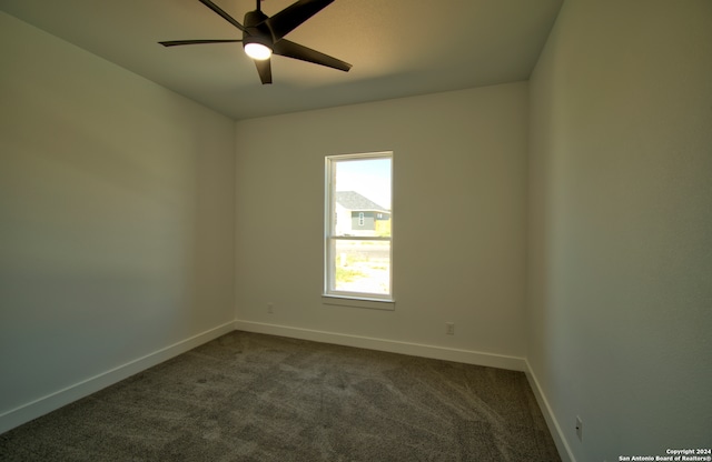 spare room with carpet and ceiling fan