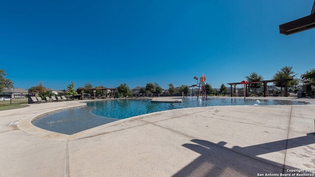 view of swimming pool with a patio