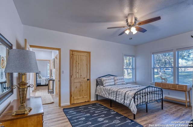 bedroom featuring ceiling fan and wood-type flooring