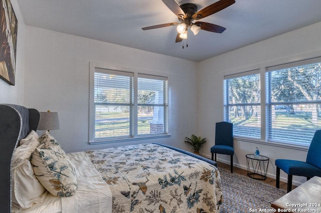 bedroom with hardwood / wood-style flooring and ceiling fan