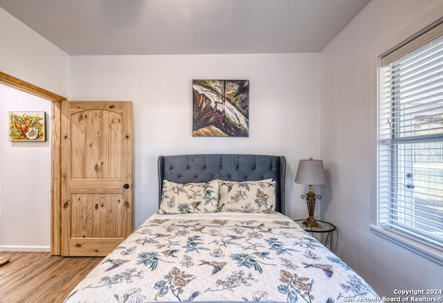 bedroom with hardwood / wood-style flooring