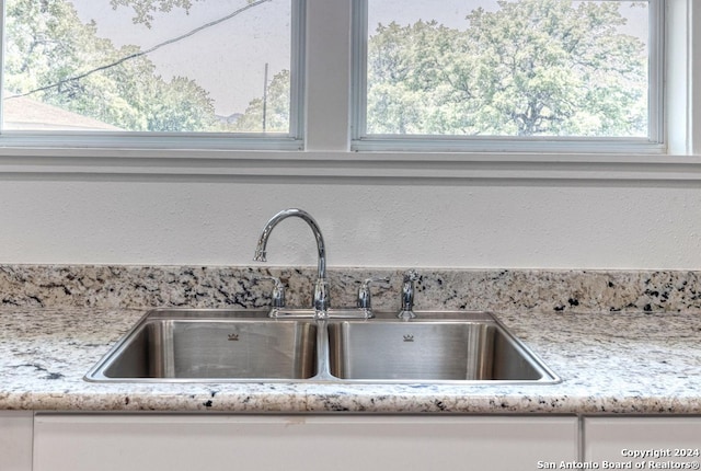 details featuring sink and light stone countertops