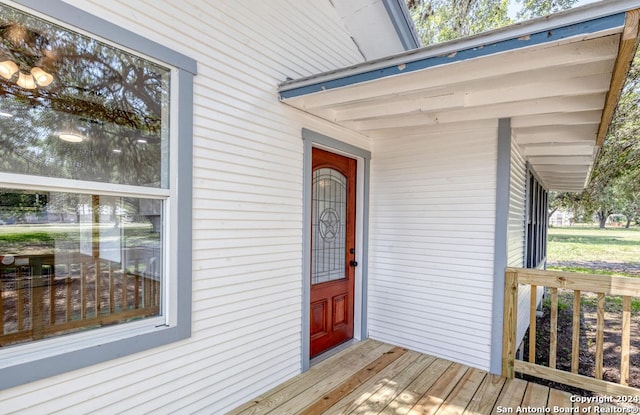 view of exterior entry featuring a deck