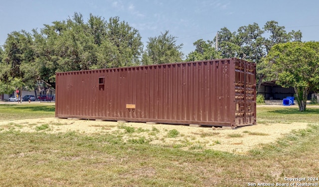 view of outbuilding featuring a yard