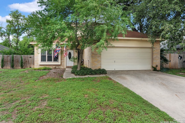 obstructed view of property with a garage and a front yard