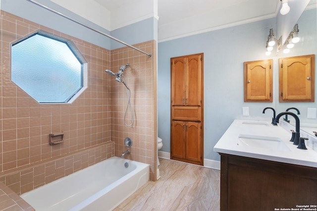 full bathroom featuring vanity, toilet, and tiled shower / bath