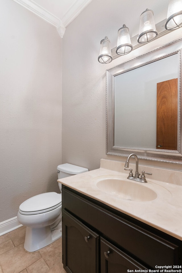 bathroom featuring crown molding, vanity, toilet, and tile patterned flooring