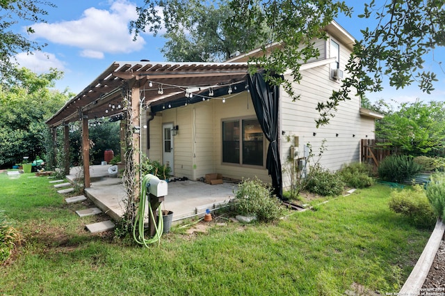 rear view of property with a pergola, a yard, and a patio