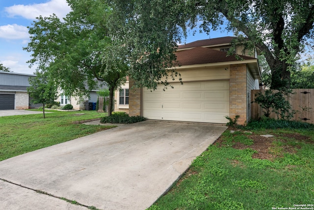 view of front of property with a garage and a front lawn