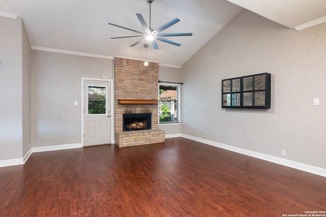 unfurnished living room featuring crown molding, a brick fireplace, ceiling fan, and dark hardwood / wood-style floors