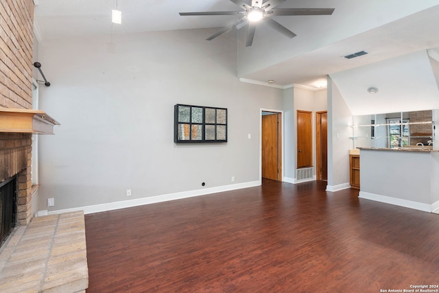 unfurnished living room featuring ceiling fan, dark hardwood / wood-style floors, high vaulted ceiling, and a fireplace